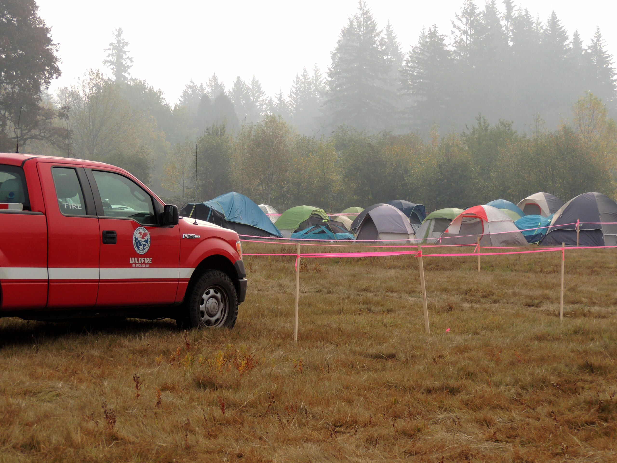 Tents begin to fill a field across from Grove Field in Camas for firefighters battling the Nakia Creek Fire. The camp will include meal areas, showers and everything crews need to rest up before heading back to the fire.