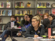 Columbia River senior Sophie Worden listens to candidates speak and takes notes Tuesday during a local candidate forum at Columbia River High School.