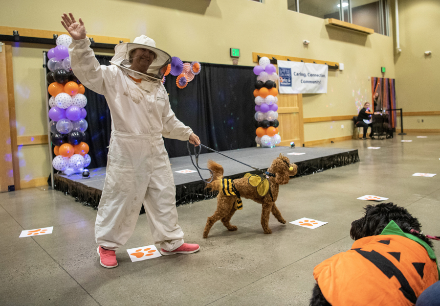 Bonita York, left, shows off Cassidy, a 1-year-old Irish doodle, on Thursday during a dog costume contest at the Battle Ground Community Center.