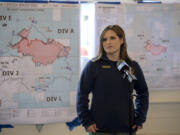 Fire Information Officer Natalie Weber speaks to members of the media Friday. A map showing the updated boundaries of the Nakia Creek Fire hangs behind her.