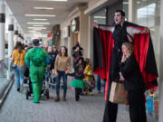 James Sharinghousen, a 7 1/2 -foot-tall vampire, menaces shoppers at the Vancouver Mall early Saturday afternoon. Booville, hosted by the Parks Foundation of Clark County and sponsored by iQ Credit Union, brought hundreds of excitedly ghoulish children and their parents to trick-or-treat at the mall.