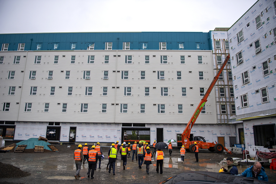 Gov. Jay Inslee joins a tour of the Fourth Plain Community Commons mixed-use building project on Oct. 23. The project will offer 106 affordable housing units and is on track to open in summer 2023.