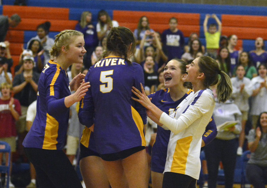 Columbia River players, from left, Logan DeJong, Lauren Dreves, Ellie Ogee and Sasha Pelkey celebrate a point in a Class 2A Greater St. Helens League volleyball match against Ridgefield on Thursday, Oct. 13, 2022 at Ridgefield High School.