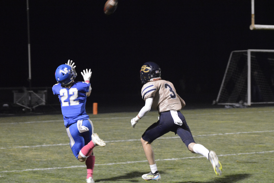 La Center's Levi Giles catches a touchdown pass ahead of Seton Catholic defender Max Ackerman on Friday, Oct. 14, 2022 at La Center High School.