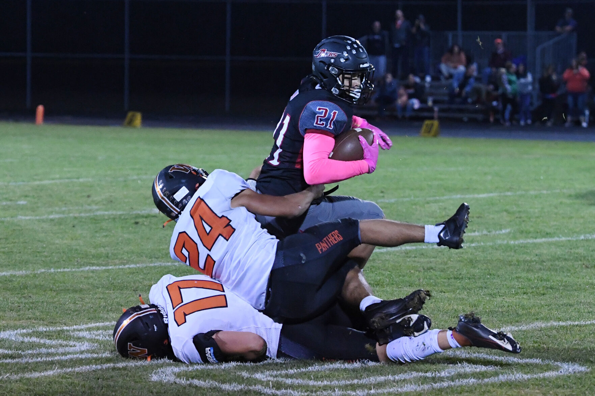 R.A. Long running back TraMayne Jenkins (21) is taken down by Washougal defender William Cooper (24) during the 2A Greater St. Helens League game Friday at Longview Memorial Stadium.