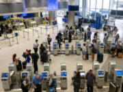People check in for departure flights at the George Bush Intercontinental Airport on Sept. 2, 2022, in Houston, Texas.