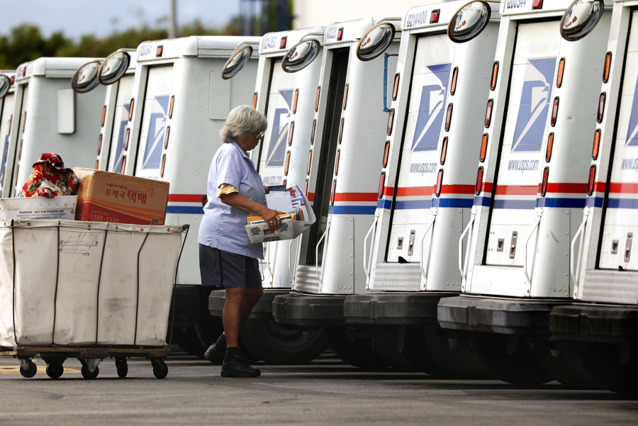 A mail carrier loads a truck for delivery at a United States post office in Torrance, California, in an August 2020 file photo. The number of thefts of checks sent via mail has surged recently.