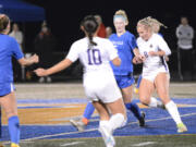 Ridgefield’s Ellie Petersen (5) and Columbia River’s Maree Seibel battle for possession of the ball during the first half on Oct. 26, 2022, at Ridgefield High School.