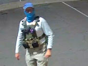 An armed individual dressed in tactical gear at a ballot drop box in Mesa, Arizona, on Oct. 21, 20221.