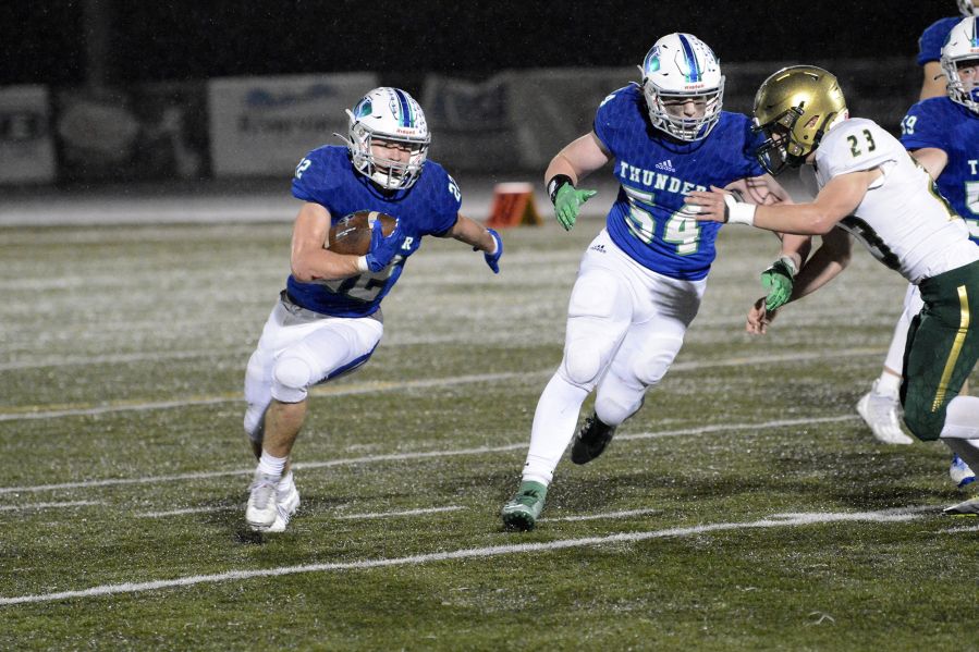Mountain View running back Porter Drake (22) gets a block from Ayden Denbo (54) against Evergreen during the 3A Greater St. Helens League tiebreaker at Doc Harris Stadium on Monday, Oct. 31, 2022.