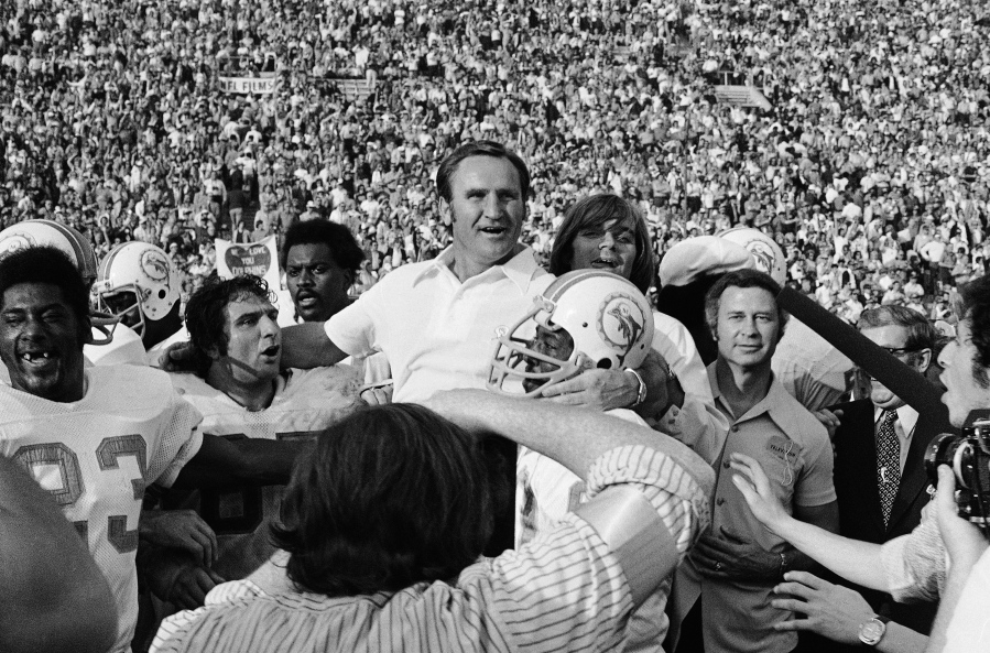 FILE - Miami Dolphins head coach Don Shula, center, is carried off the field after his team won the NFL football Super Bowl game over the Washington Redskins in Los Angeles, Jan. 14, 1973. It's quite likely no other Miami team will ever live up to that perfect '72 Dolphins team. That team has almost taken a larger-than-life meaning in the hearts and minds of sports fans. What that team did 50 years ago was difficult enough, but in today's NFL it's a nearly unattainable feat.