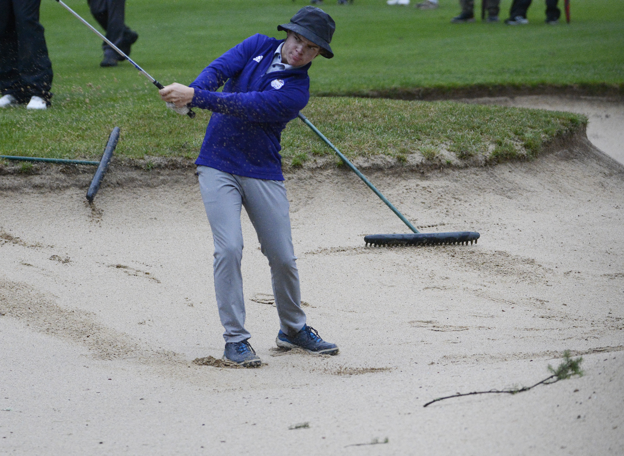 Columbia River’s Noah Larson hits out of bunker on the No. 1 hole at Orchard Hills Golf Club in Washougal during a playoff at the Class 2A District 4 golf tournament on Tuesday, Oct.
