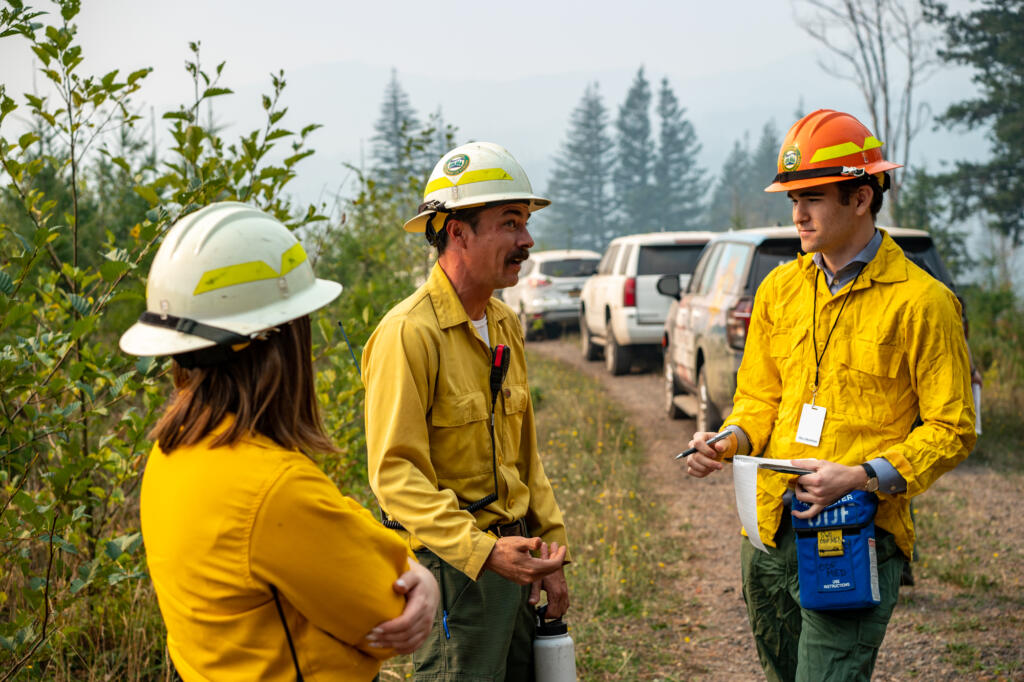 Columbian Reporter William Seekamp, right — shoe size 11 — interviews division supervisor Tyler Arbogast of Pendleton, Ore., while out on the fire line for the Nakia Creek Fire on Wednesday.