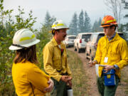 Columbian Reporter William Seekamp, right — shoe size 11 — interviews division supervisor Tyler Arbogast of Pendleton, Ore., while out on the fire line for the Nakia Creek Fire on Wednesday.