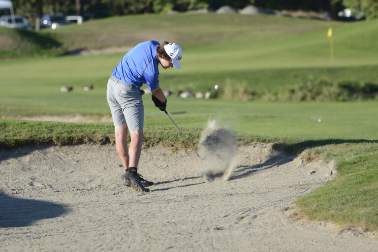Mountain View’s Grady Millar hits out of a bunker on No. 18 at Heron Lakes Golf Course in Portland during the 3A district golf tournament on Tuesday, Oct. 11, 2022.
