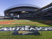 A logo for the baseball playoffs is on the field Friday, Oct. 14, 2022, the day before Game 3 of an AL Division Series between the Houston Astros and the Seattle Mariners in Seattle.