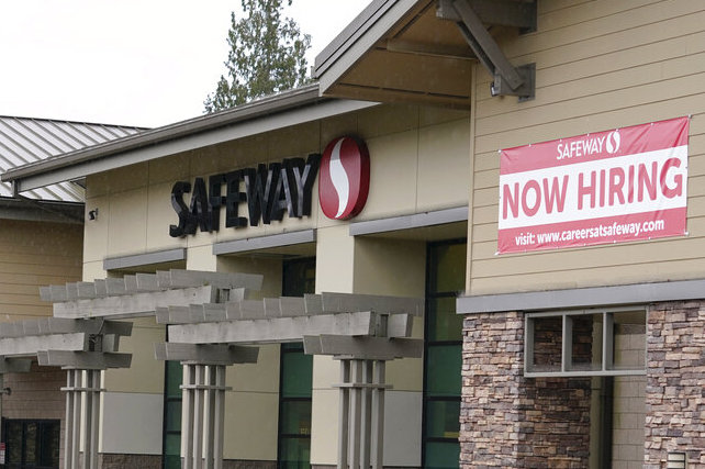 A signs reads “Now Hiring” at a Safeway grocery store in Seattle in 2021.