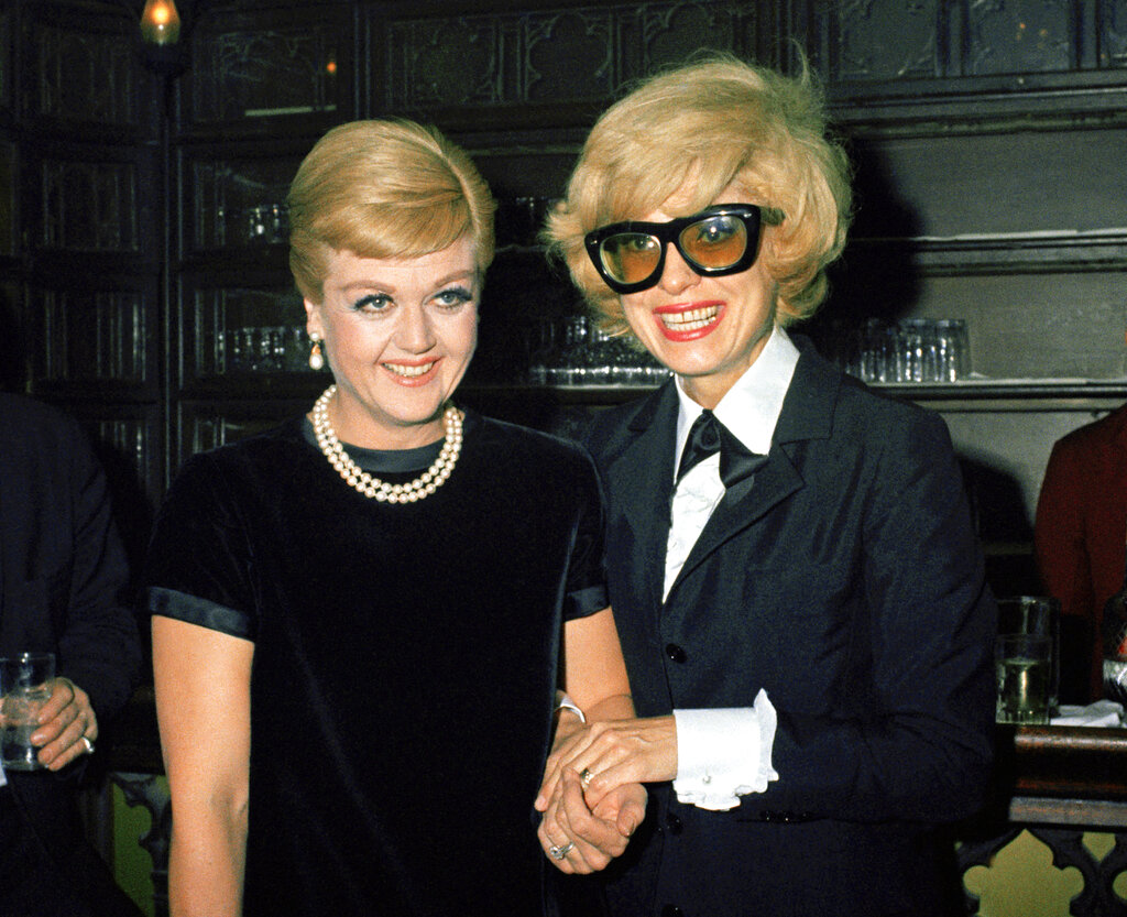 FILE - Anglea Lansbury, left, and Carol Channing appear at a party at Sardis in New York on March 16, 1967. Lansbury, the big-eyed, scene-stealing British actress who kicked up her heels in the Broadway musicals “Mame” and “Gypsy” and solved endless murders as crime novelist Jessica Fletcher in the long-running TV series “Murder, She Wrote,” died peacefully at her home in Los Angeles on Tuesday. She was 96.