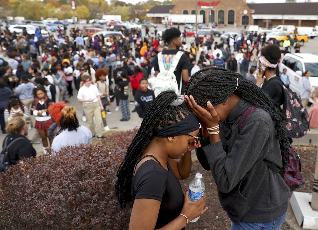 Students stand in a parking lot near the Central Visual &amp; Performing Arts High School after a reported shooting at the school in St. Louis on Monday, Oct. 24, 2022. (David Carson/St.
