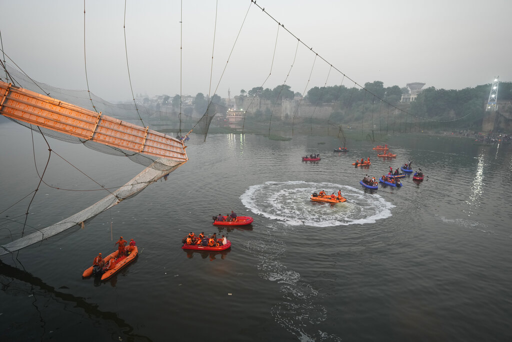 Search and rescue work is going on as a cable suspension bridge collapsed in Morbi town of western state Gujarat, India, Monday, Oct. 31, 2022. The century-old cable suspension bridge collapsed into the river Sunday evening, sending hundreds plunging in the water, officials said.