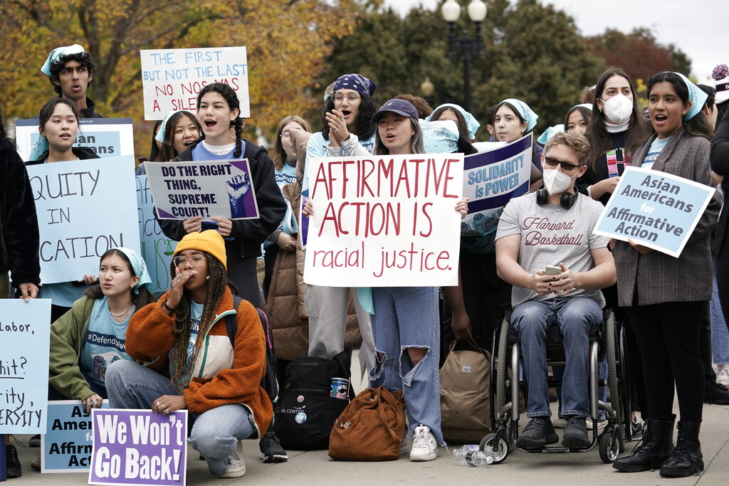 People rally outside the Supreme Court as the court begins to hear oral arguments in two cases that could decide the future of affirmative action in college admissions, Monday, Oct. 31, 2022, in Washington. (AP Photo/J.