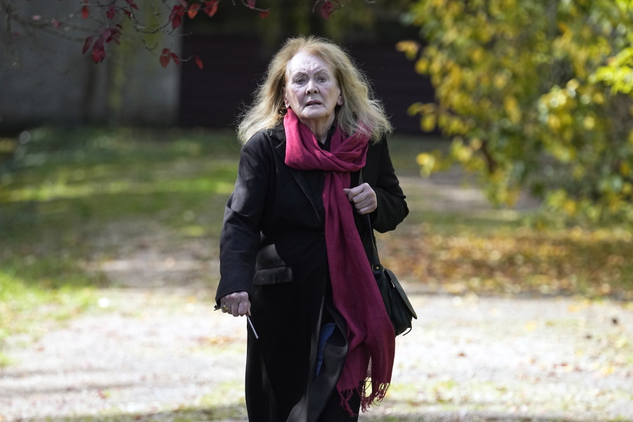 French author Annie Ernaux leaves her home in Cergy-Pontoise, outside Paris, Thursday, Oct. 6, 2022. The 82-year-old was cited for "the courage and clinical acuity with which she uncovers the roots, estrangements and collective restraints of personal memory," the Nobel committee said.