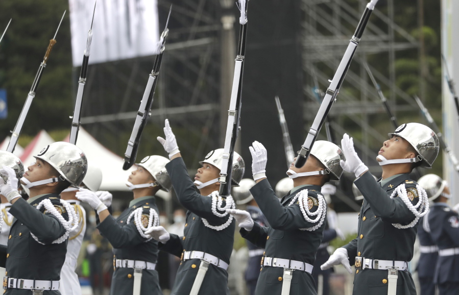 The military honor guard perform during the National Day celebrations in front of the Presidential Building in Taipei, Taiwan, Monday, Oct. 10, 2022.