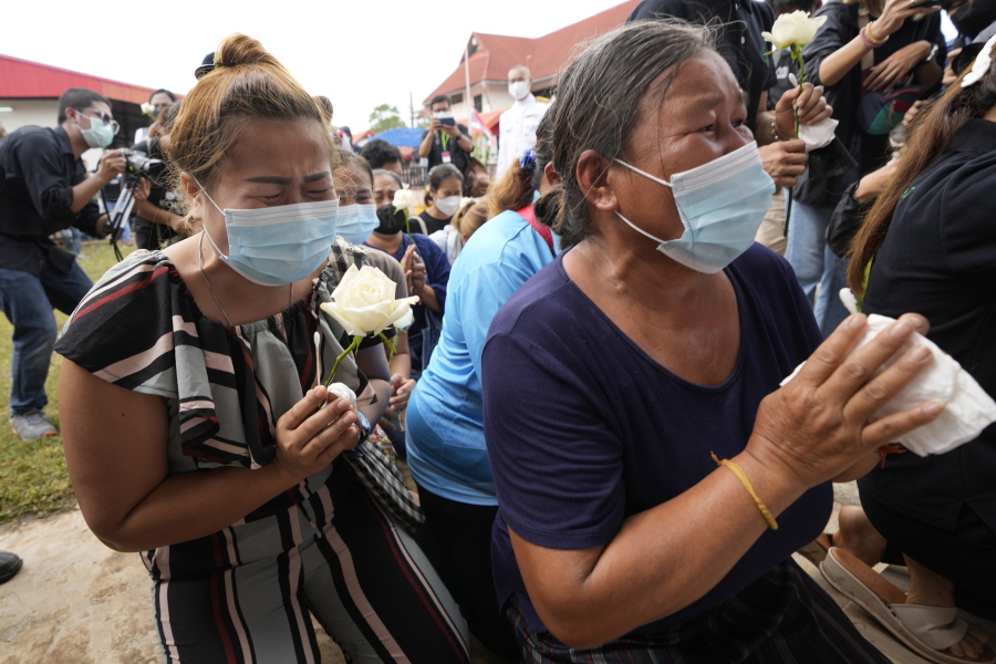 Relatives pray during a ceremony for those killed in the attack on the Young Children's Development Center in the rural town of Uthai Sawan, north eastern Thailand, Friday, Oct. 7, 2022. A former policeman facing a drug charge burst into a day care center in northeastern Thailand on Thursday, killing dozens of preschoolers and teachers before shooting more people as he fled in the deadliest rampage in the nation's history.