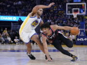 Portland Trail Blazers guard Shaedon Sharpe (17) drives to the basket against Golden State Warriors forward Anthony Lamb (40) during the first half of an NBA preseason basketball game in San Francisco, Tuesday, Oct. 11, 2022. (AP Photo/Godofredo A.