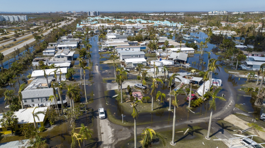 Water floods a damaged trailer park in Fort Myers, Fla., on Saturday, Oct. 1, 2022, after Hurricane Ian passed by the area.