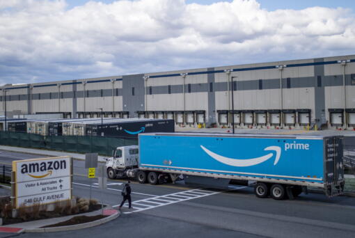 FILE - A truck arrives at the Amazon warehouse facility on the Staten Island borough of New York, April 1, 2022. Amazon has suspended at least 50 warehouse workers who refused to work their shifts following a trash compactor fire at one of its New York facilities, according to union organizers. The company suspended the workers, with pay, on Tuesday, Oct. 4, 2022 a day after the fire disrupted operations at the Staten Island warehouse that voted to unionize earlier this year.