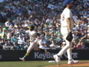 Oakland Athletics' Nick Allen, left, rounds third after hitting a two-run home run as Seattle Mariners starting pitcher Robbie Ray, right, walks to the mound during the sixth inning of a baseball game, Sunday, Oct. 2, 2022, in Seattle.