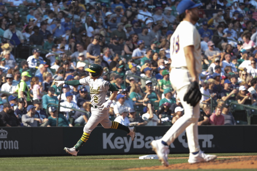Oakland Athletics' Nick Allen, left, rounds third after hitting a two-run home run as Seattle Mariners starting pitcher Robbie Ray, right, walks to the mound during the sixth inning of a baseball game, Sunday, Oct. 2, 2022, in Seattle.