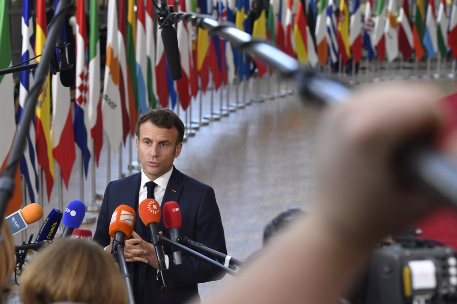 France's President Emmanuel Macron speaks with the media as he arrives for an EU summit in Brussels, Thursday, Oct. 20, 2022. European Union leaders were heading into a two-day summit Thursday with opposing views on whether, and how, the bloc could impose a gas price cap to contain the energy crisis fueled by Russian President Vladimir Putin's invasion of Ukraine and his strategy to choke off gas supplies to the bloc at will.