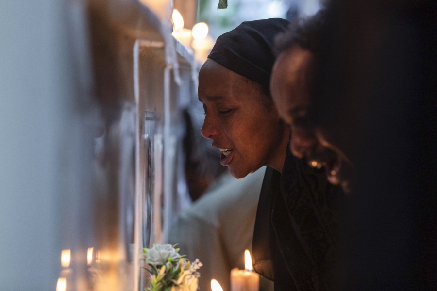 FILE - Ethiopian relatives of some of the crash victims light candles and gather at an anniversary memorial service at the Holy Trinity Cathedral in Addis Ababa, Ethiopia, March 8, 2020, to remember those who died when Ethiopian Airlines flight ET302, a Boeing 737 Max, crashed shortly after takeoff on March 10, 2019, killing all 157 on board. A federal judge ruled Friday, Oct. 21, 2022, that relatives of people who were killed in the crashes of two Boeing 737 Max planes are crime victims under federal law, finding that the Justice Department should have notified families before privately negotiating a settlement that spared Boeing from criminal prosecution.