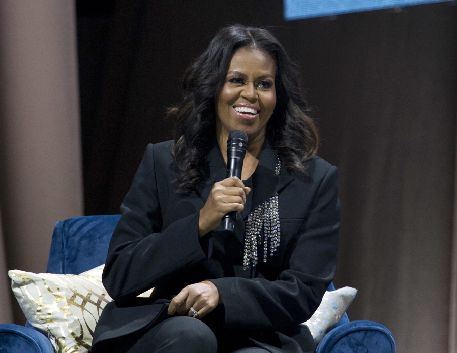FILE - Former first lady Michelle Obama speaks to the crowd as she presents her anticipated memoir "Becoming" during her book tour stop in Washington, on Nov. 17, 2018. Obama plans a six-city tour this fall in support of her new book, "The Light We Carry: Overcoming in Uncertain Times," beginning mid-November in Washington. D.C. and ending a month later in Los Angeles.