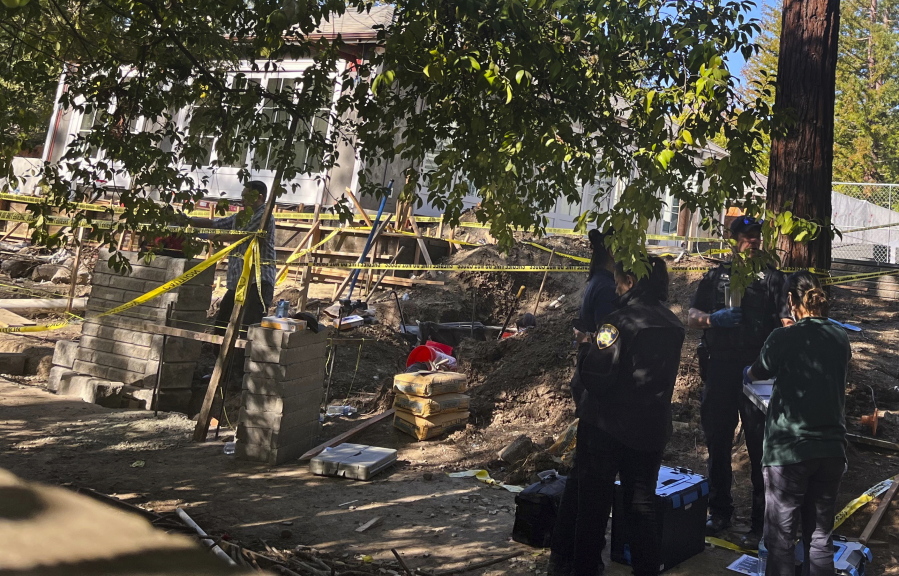 Atherton police continue to investigate the discovery of a vehicle found buried in the yard of a home in the 300 block of Stockbridge Avenue in Atherton, Calif., Friday, Oct. 21, 2022.
