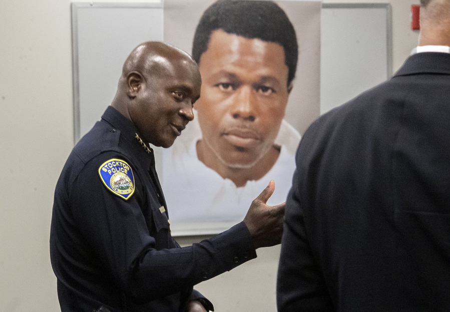 Stockton Police Chief Stanley McFadden speaks during a press conference at the Stockton Police Department headquarters in Stockton, Calif., on the arrest of suspect Wesley Brownlee in the Stockton serial killings on Saturday, Oct. 15, 2022. Behind McFadden is a booking photo of Brownlee.