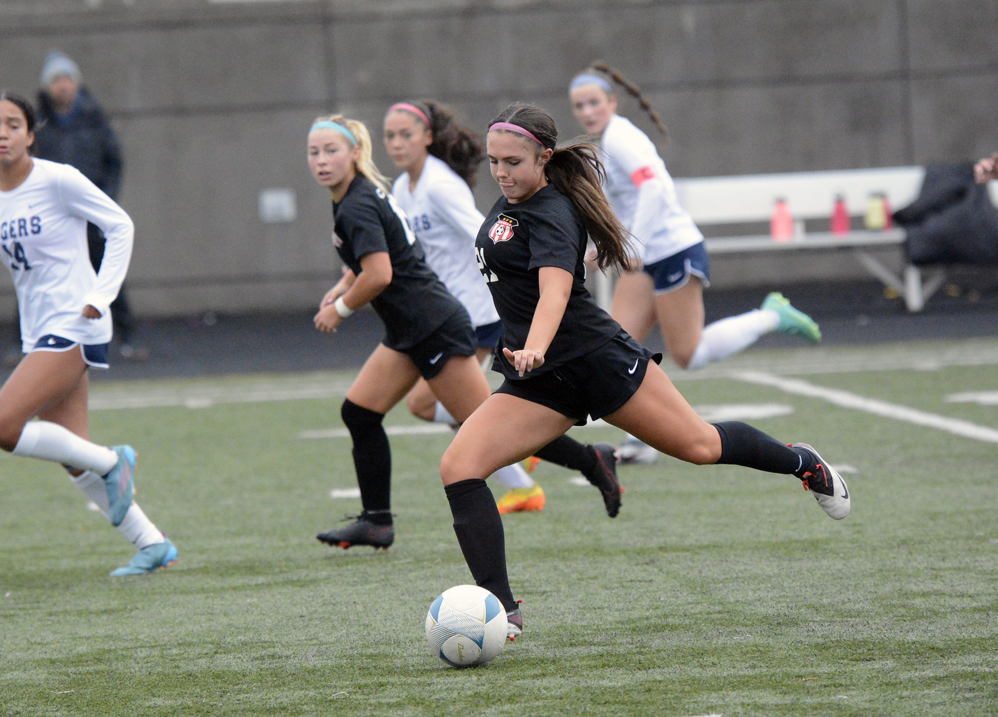 Camas senior Bella Burns strikes the ball during Camas' 3-0 win over Rogers-Puyallup in a 4A bi-district soccer playoff match at Doc Harris Stadium on Saturday, Oct. 29, 2022.