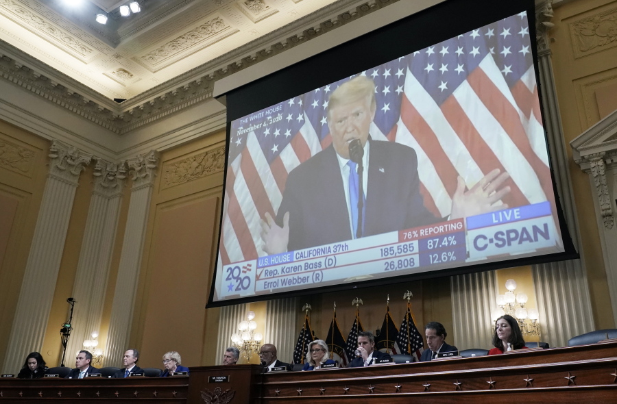 FILE - A video of then-President Donald Trump speaking is displayed as the House select committee investigating the Jan. 6 attack on the U.S. Capitol holds a hearing on Capitol Hill in Washington, Thursday, Oct. 13, 2022. In an extraordinary step, the House Jan. 6 committee on Thursday voted to subpoena former President Donald Trump. (AP Photo/J.