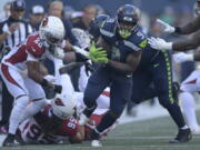 Seattle Seahawks running back Kenneth Walker III (9) runs against the Arizona Cardinals during the second half of an NFL football game in Seattle, Sunday, Oct. 16, 2022.