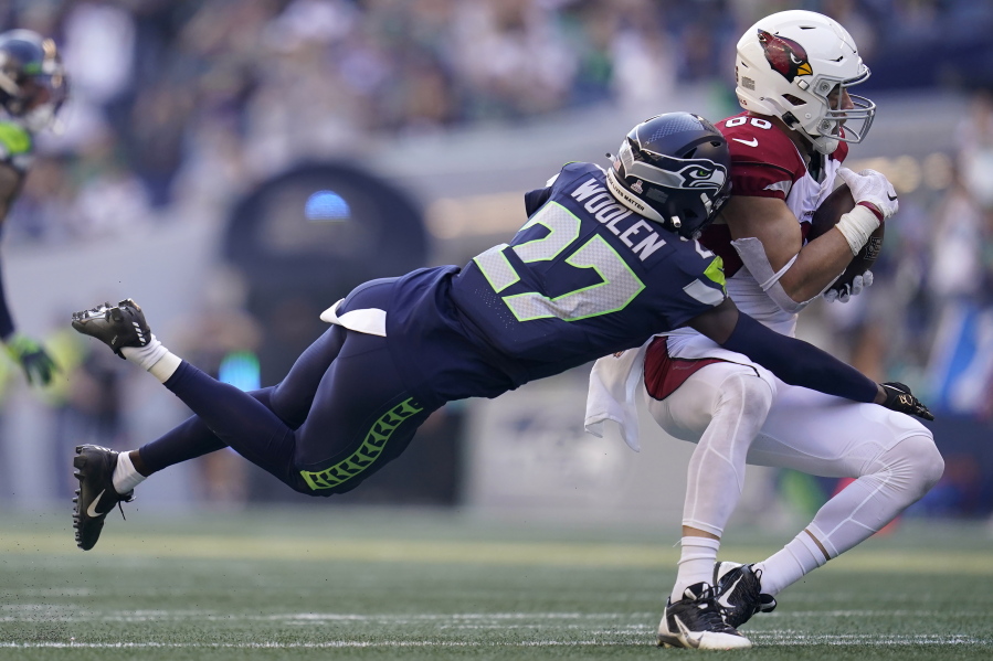 Arizona Cardinals tight end Zach Ertz, right, catches a pass in front of Seattle Seahawks cornerback Tariq Woolen (27) during the second half of an NFL football game in Seattle, Sunday, Oct. 16, 2022.