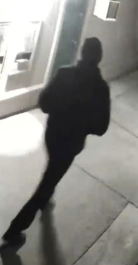 In this undated surveillance image released by the Stockton Police Department, a grainy still image of a "person of interest," dressed all in black and wearing a black cap, who appeared in videos from several of the homicide crime scenes in Stockton. Ballistics tests have linked the fatal shootings of six men and the wounding of one woman in California-- all potentially at the hands of a serial killer -- in crimes going back more than a year, police said Monday.