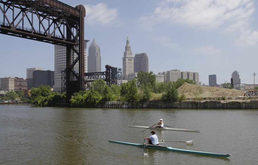 Two rowers paddle along the Cuyahoga River in Cleveland on July 12, 2011. Tuesday is the 50th anniversary of Congress passing the Clean Water Act to protect U.S. waterways from abuses like the oily industrial pollution that caused Ohio's Cuyahoga River to catch on fire in 1969.
