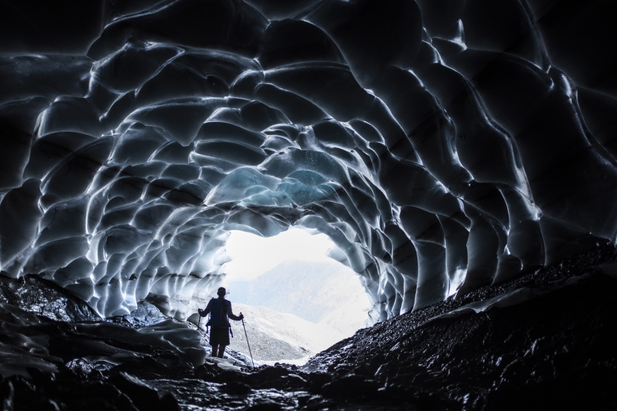 A man stands in a glacier cave at the Sardona glacier July 27 in Vaettis, Switzerland. The melting glacier has revealed a cave. Faced with increasing demand for alpine water resources at a time of accelerating glacier melt, policymakers from eight European countries are meeting in Switzerland to prevent a dispute over diminishing water resources from the highest peaks in the Alps.