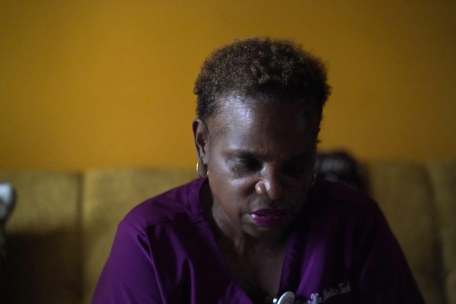 Karen Nix sits in her home before leaving for her evening work shift in New Orleans, Tuesday, Aug. 23, 2022. Nix tells her story of surviving hurricanes Katrina and Ida while living with cerebral palsy.