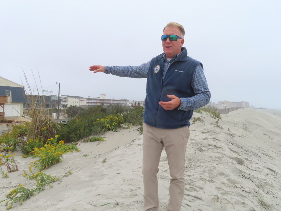 Mayor Patrick Rosenello stands atop a recently repaired dune in North Wildwood, N.J., on Tuesday, Oct. 25, 2022. The town used bulldozers to push sand back into piles to repair severe erosion from recent storms, despite a directive from state environmental officials not to do the work until the proper studies and planning took place.