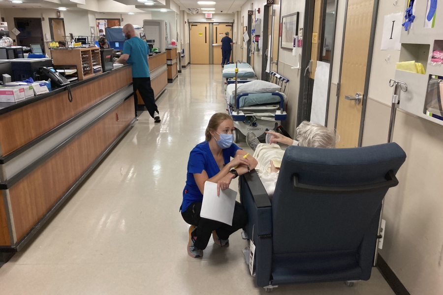 A nurse talks to a patient in the emergency room at Salem Hospital in Salem, Ore., on Aug. 20, 2021. Oregon voters will decide in the November election whether to amend the state Constitution to declare affordable health care a fundamental human right.