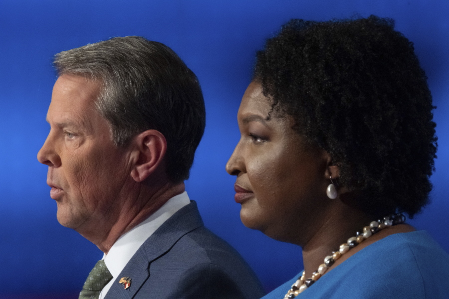 Republican Georgia Gov. Brian Kemp, left, and Democratic challenger Stacey Abrams face off in a televised debate, in Atlanta, Sunday, Oct. 30, 2022.