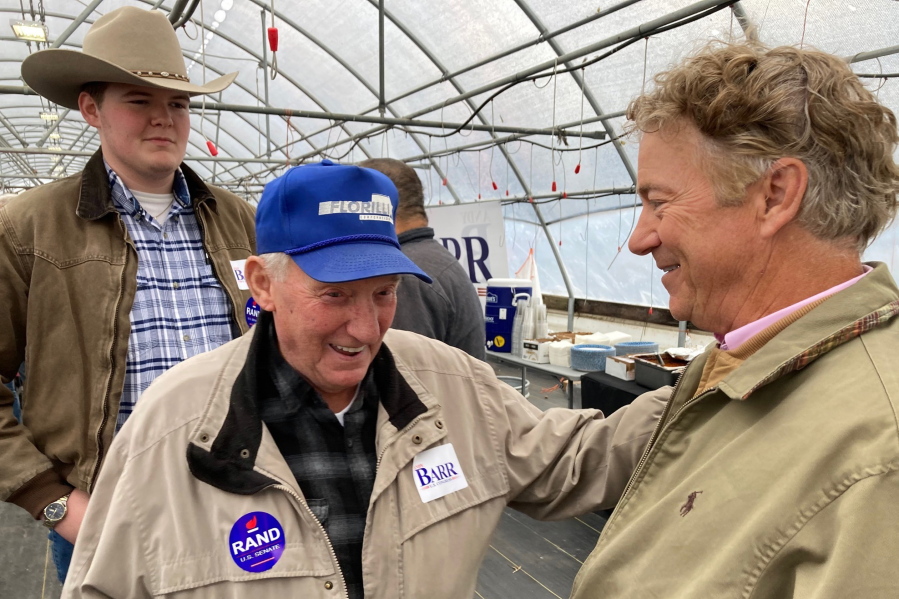 U.S. Sen. Rand Paul, R-Ky., right, chats with supporters at a fish fry on Tuesday, Oct. 18, 2022, in Garrard County, near Lancaster, Ky. Paul is seeking a third term in next month's midterm election.